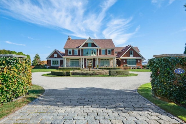 view of front of home with driveway and a chimney