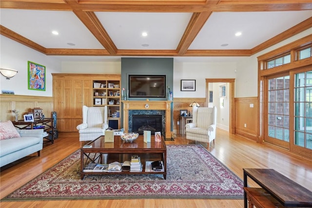 living room with wainscoting, coffered ceiling, and beam ceiling