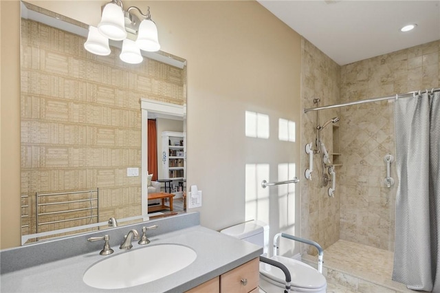 full bathroom with toilet, a chandelier, tiled shower, and vanity