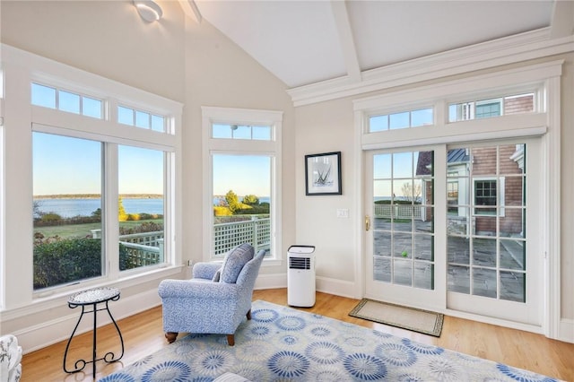 interior space with a water view and vaulted ceiling