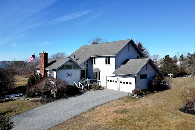 view of front of home with a garage, roof with shingles, driveway, and a front lawn