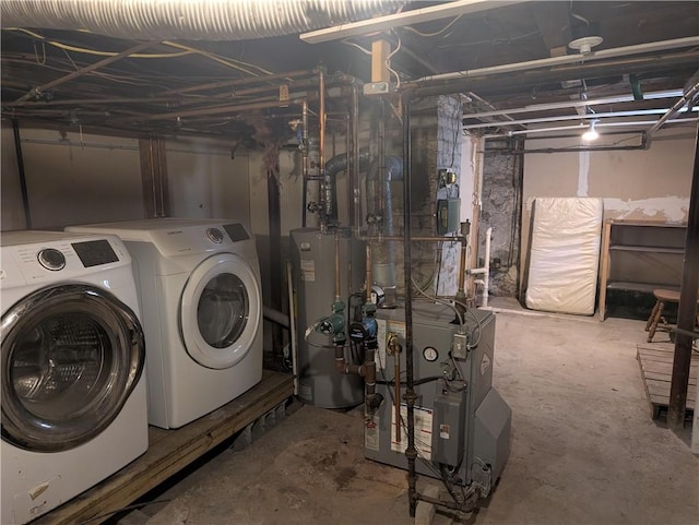 unfinished basement featuring water heater, a heating unit, and washer and dryer