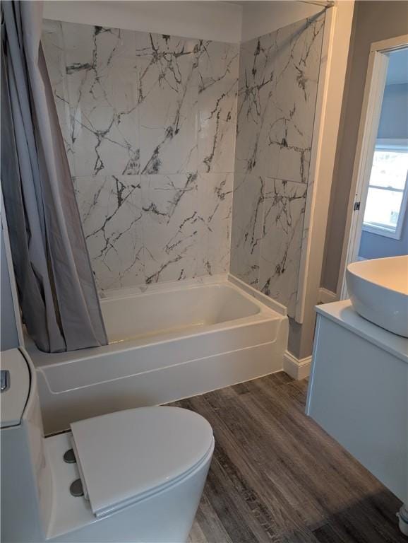 full bathroom with toilet, vanity, wood finished floors, and shower / bath combo with shower curtain