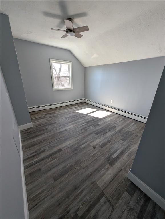 bonus room with lofted ceiling, a baseboard radiator, dark wood-style floors, and baseboards