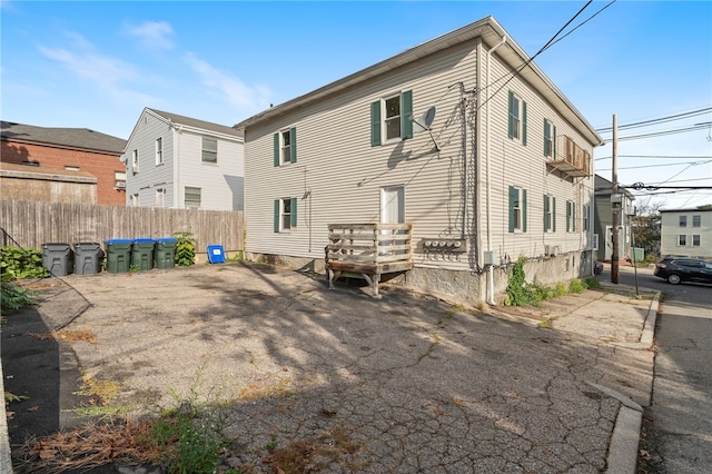 back of house with fence