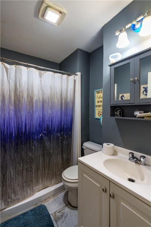 full bath featuring a stall shower, vanity, and toilet