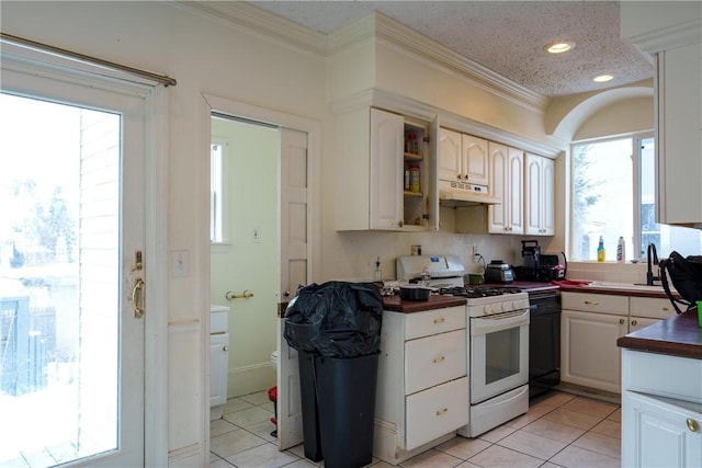 kitchen with dark countertops, white range with gas stovetop, crown molding, and under cabinet range hood