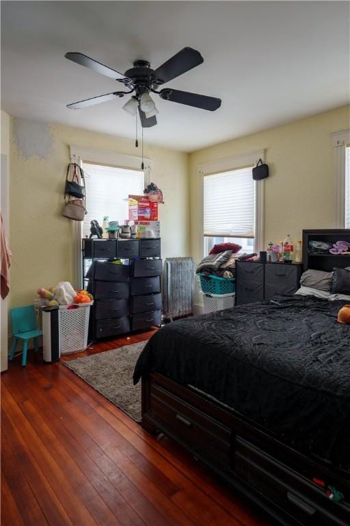 bedroom featuring wood-type flooring and a ceiling fan