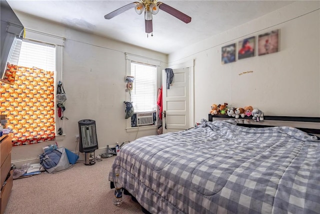 carpeted bedroom featuring a ceiling fan and cooling unit