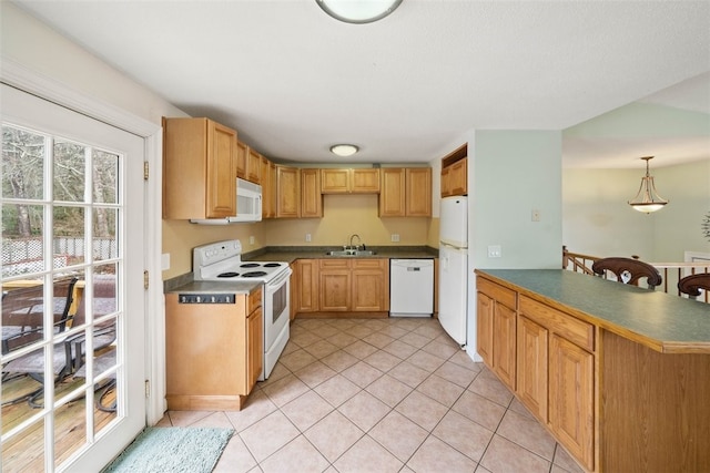 kitchen with dark countertops, white appliances, a sink, and light tile patterned floors