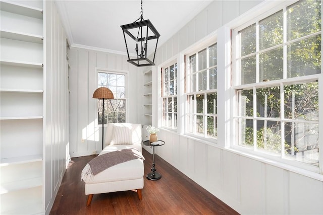 sunroom featuring a chandelier