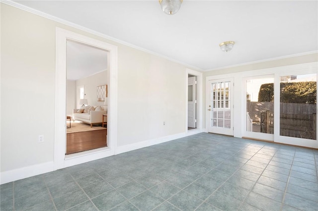 empty room with crown molding, baseboards, and a healthy amount of sunlight