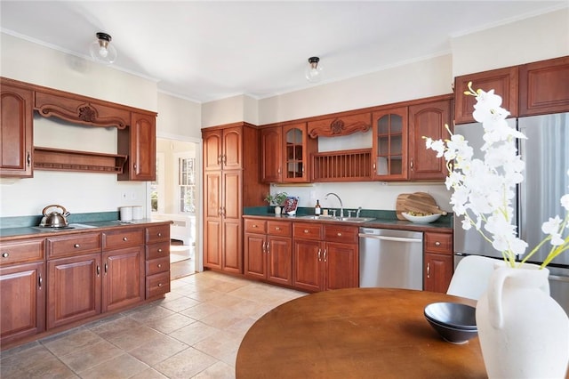 kitchen with open shelves, dark countertops, appliances with stainless steel finishes, glass insert cabinets, and a sink