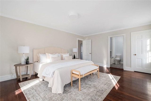 bedroom with hardwood / wood-style flooring, baseboards, crown molding, and ensuite bathroom