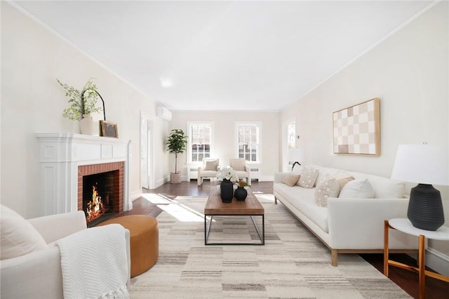 living area with crown molding, a fireplace, baseboards, and wood finished floors