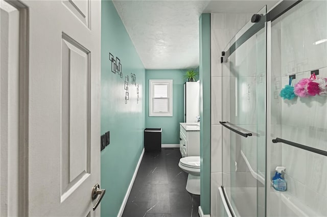 bathroom with a textured ceiling, tile patterned flooring, toilet, vanity, and baseboards