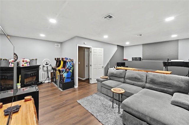 living room with visible vents, wood finished floors, and recessed lighting