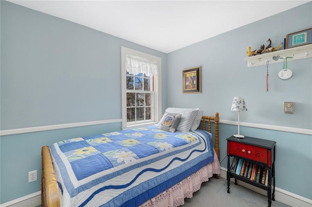 carpeted bedroom featuring baseboards