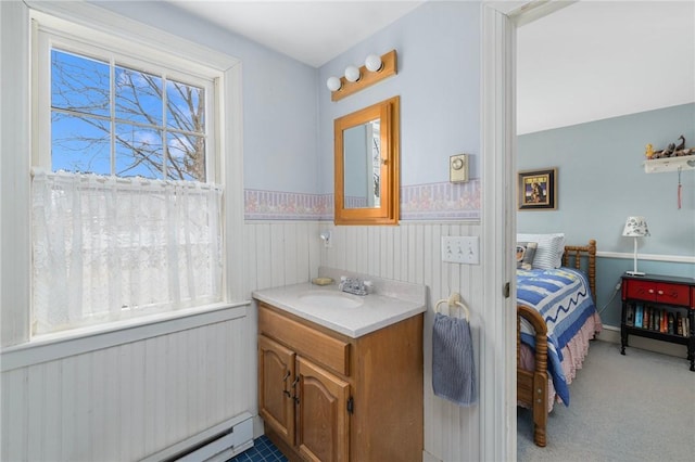 bathroom with a wainscoted wall, a baseboard radiator, plenty of natural light, and vanity