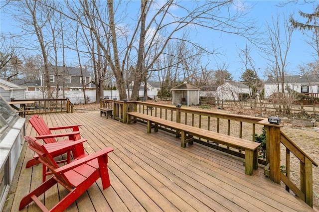 wooden deck featuring a fenced backyard and a residential view