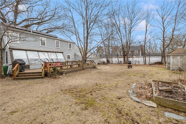 view of yard with a fenced backyard, a vegetable garden, and a deck