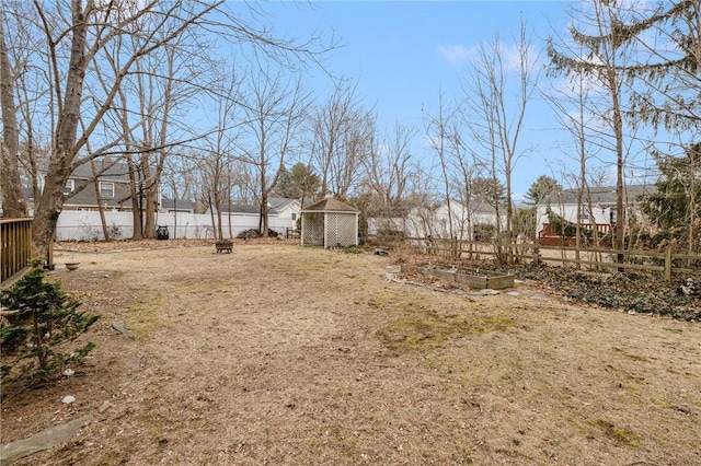 view of yard featuring an outdoor structure, a vegetable garden, and fence