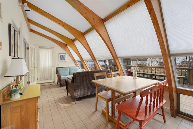 dining area featuring vaulted ceiling with beams and light tile patterned floors