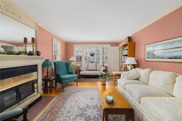 living room with a fireplace with flush hearth and crown molding