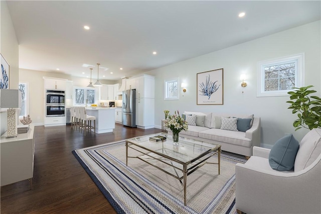 living room featuring baseboards, dark wood-type flooring, and recessed lighting