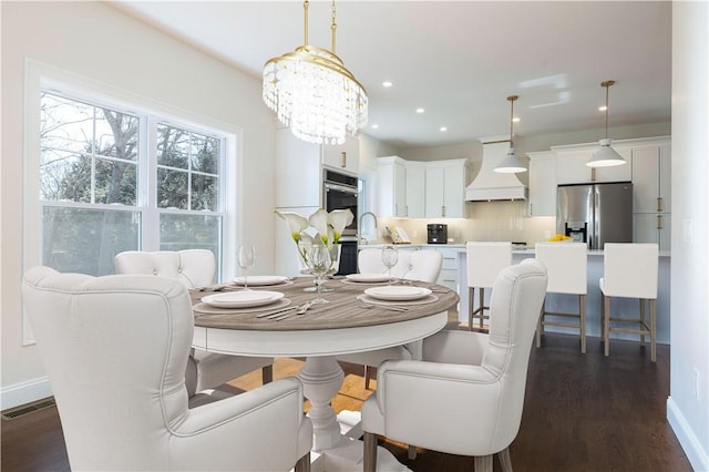 dining area with dark wood-style floors, recessed lighting, visible vents, and baseboards