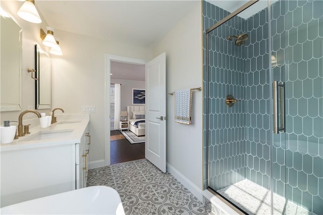 ensuite bathroom with a sink, a shower stall, and ensuite bathroom