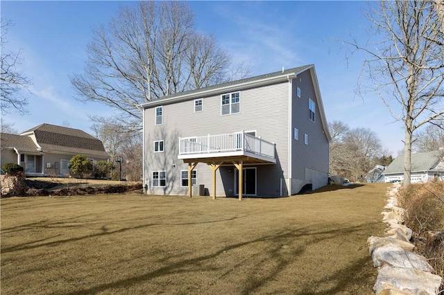 back of house with a lawn and a deck