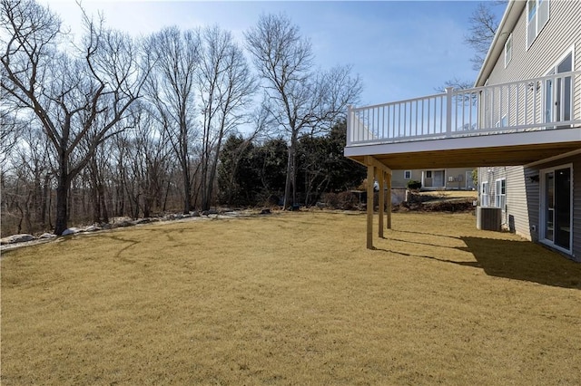 view of yard with central AC and a deck