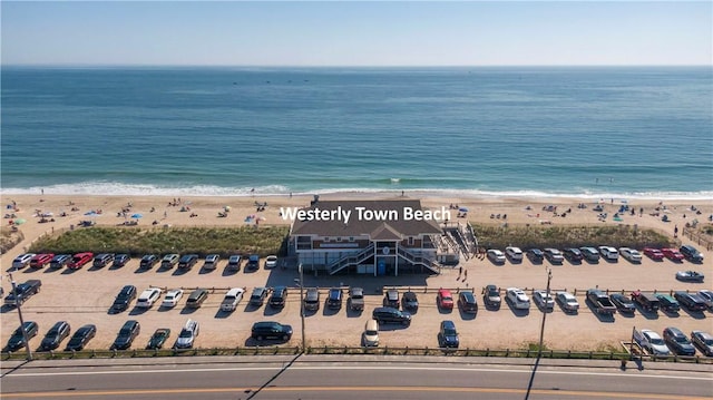 birds eye view of property featuring a beach view and a water view