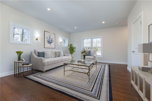 living area featuring baseboards, dark wood-type flooring, and recessed lighting