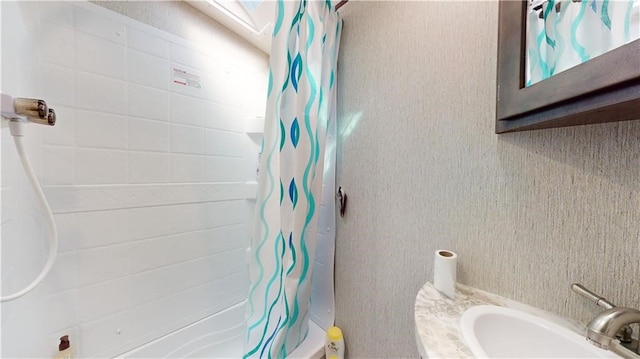 bathroom featuring a sink and shower / bath combo with shower curtain