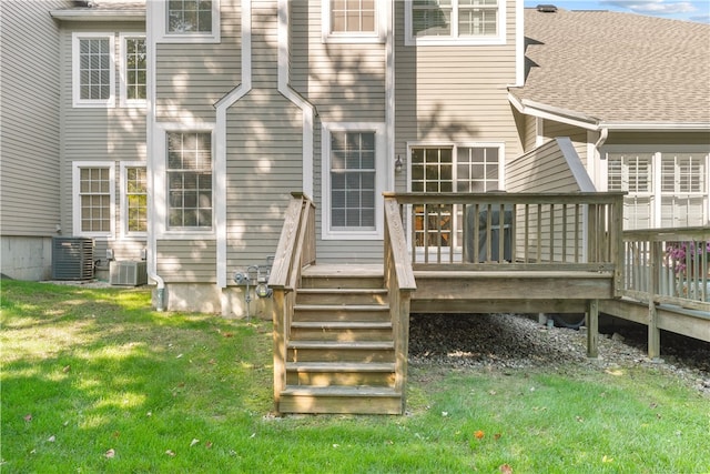 back of property featuring a yard, a wooden deck, and central air condition unit