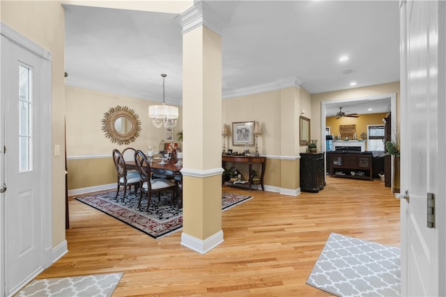 entrance foyer featuring a healthy amount of sunlight, light wood-style flooring, and crown molding