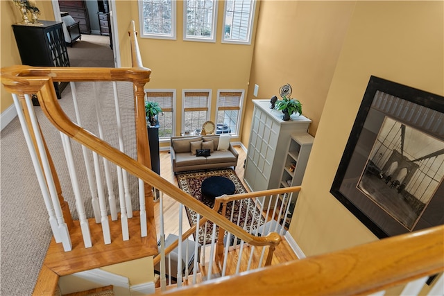 staircase featuring baseboards and a wealth of natural light