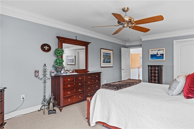 bedroom with ornamental molding, light colored carpet, ceiling fan, and baseboards