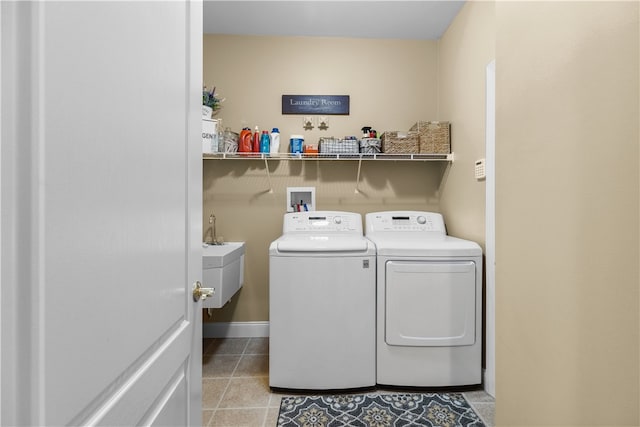 laundry room with light tile patterned floors, laundry area, a sink, baseboards, and washer and dryer