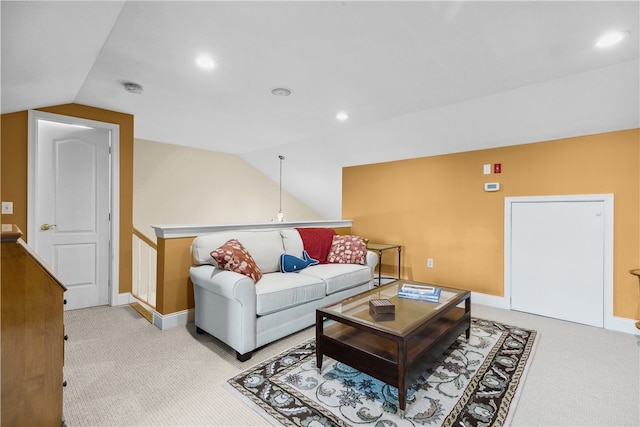 living room featuring vaulted ceiling, baseboards, and light colored carpet