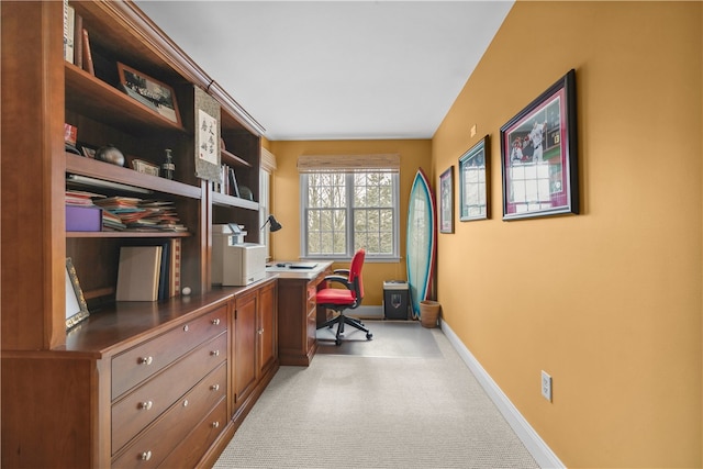 office with light colored carpet and baseboards