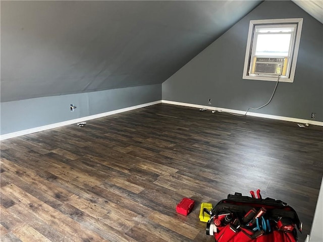 additional living space featuring vaulted ceiling, dark wood-style flooring, cooling unit, and baseboards