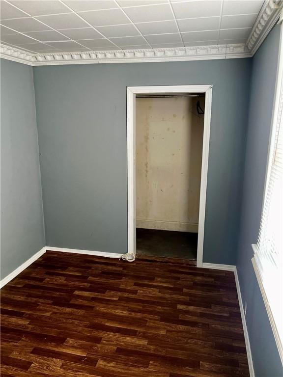 empty room with baseboards and wood finished floors