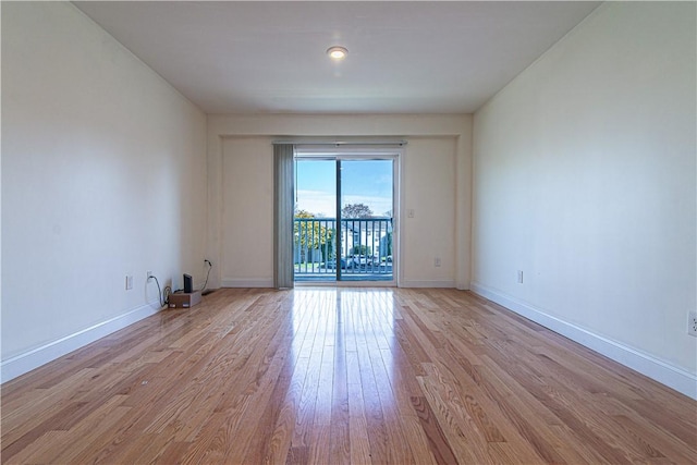 empty room featuring light wood-style floors and baseboards