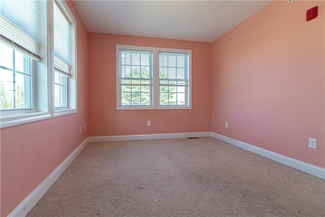 spare room with baseboards