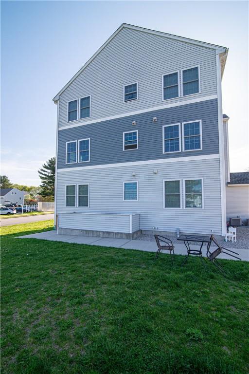 back of house featuring a patio area and a yard