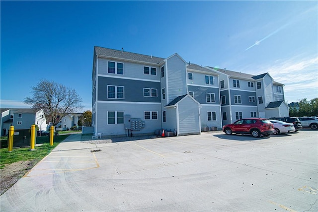 exterior space featuring uncovered parking and a residential view