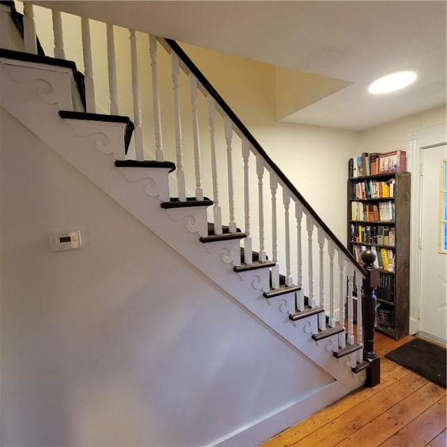 stairway with hardwood / wood-style flooring